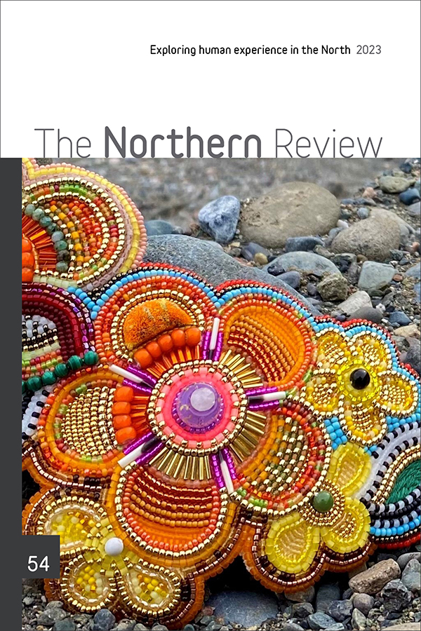 Cover of The Northern Review 54, with close-up photo of colourful floral beadwork laying on river rocks. Artist Kaylyn Baker Designs